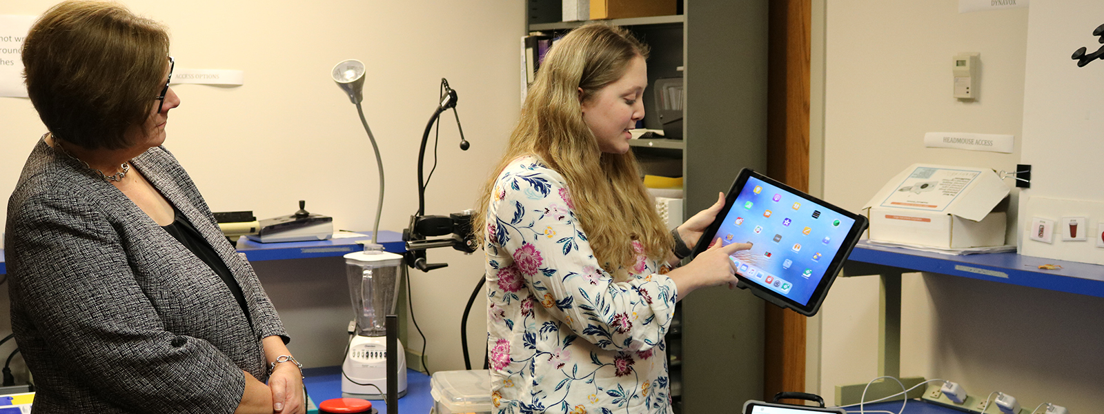 Kelly Woodworth, a speech-language pathology graduate student, demonstrates how an iPad might be used as an AAC device.