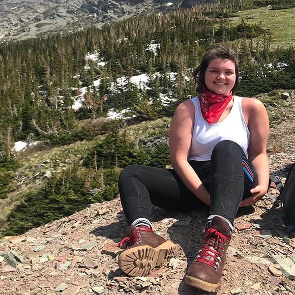 Student sitting on mountaintop