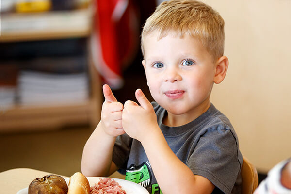 Boy showing thumbs up.