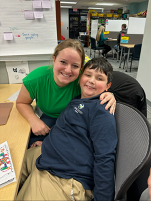 Max Petersen smiles for a photo with his tutor at the Schmoker Reading Center