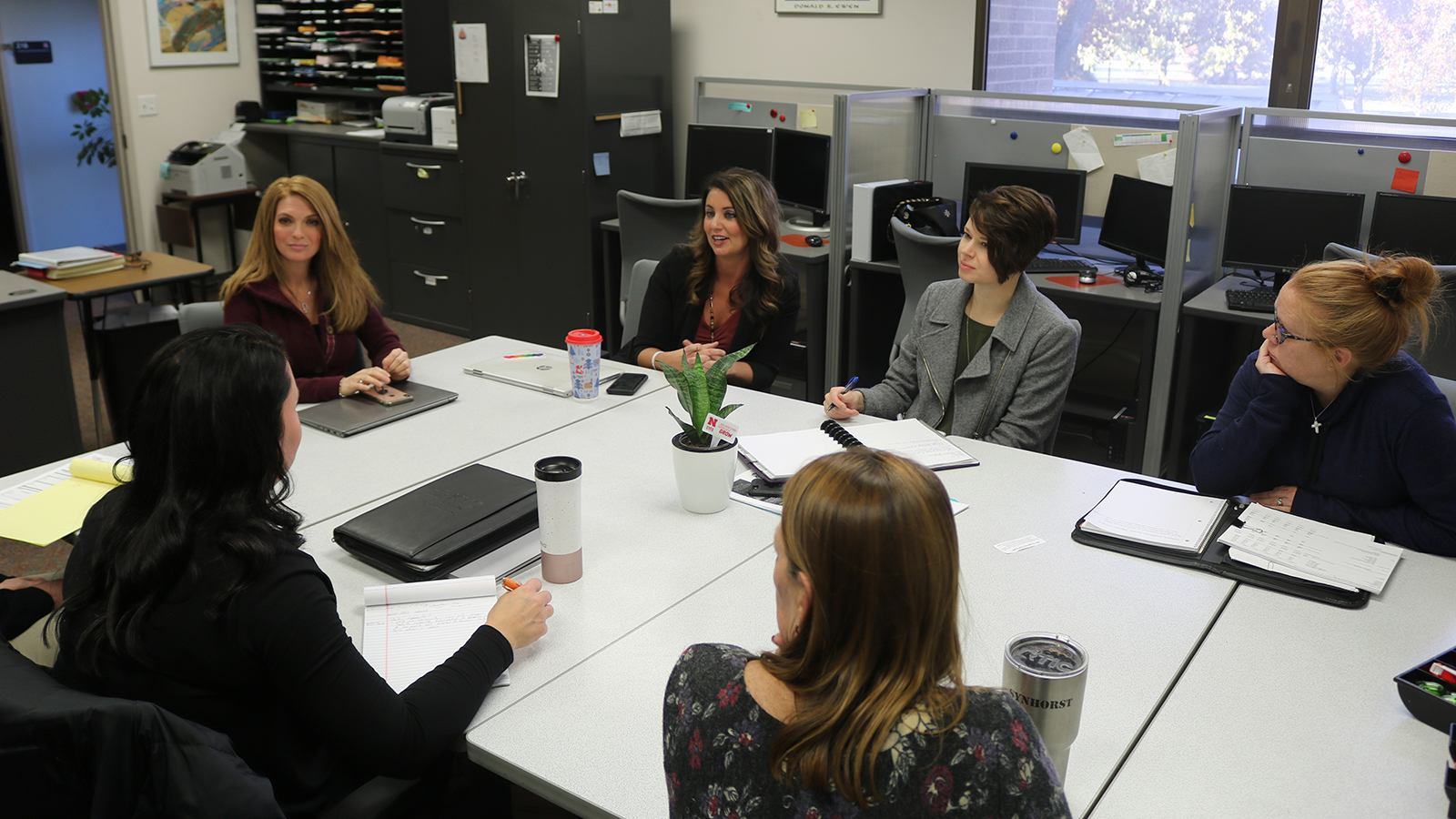 Individuals from the Academy for Child and Family Well Being, and KVC Nebraska discuss their collaboration for the Fostering Educational Success project during a planning meeting.