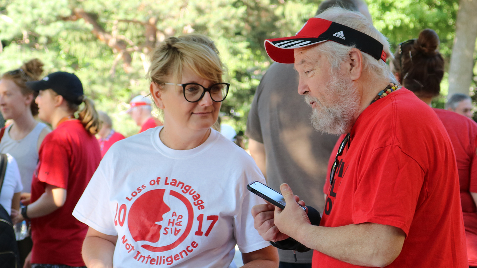 Kristy Weissling speaks with a client from the Barkley Speech Language and Hearing Clinic prior to the start of the 2019 Aphasia Awareness Walk