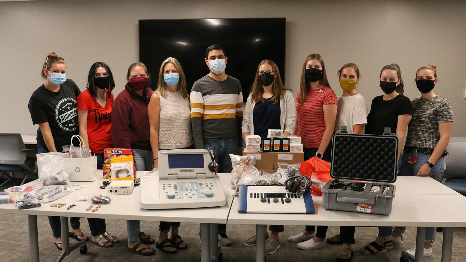Stacie Ray, Hannah Ditmars and seven Husker audiology students pose for a photo with Dr. Marvin Gonzalez and all the supplies they sent with him to Nicaragua in August 2021.