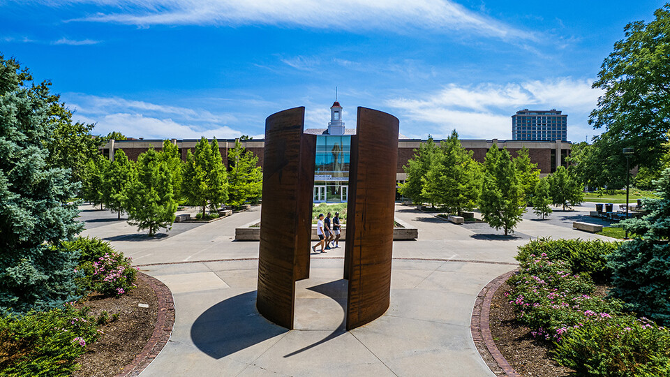 A view from the North of Adele Learning Commons looking through a tall, parallel sculpture.