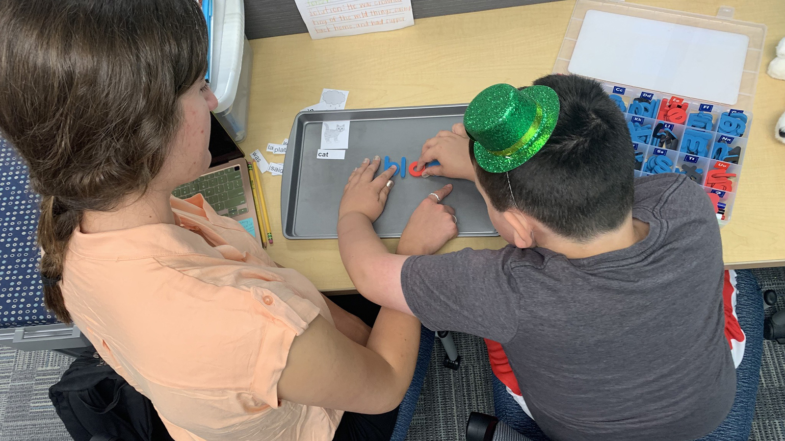 Devin Shaughnessy, an elementary and special education major, helps Max Petersen build words during a tutoring session at the Schmoker Reading Center 