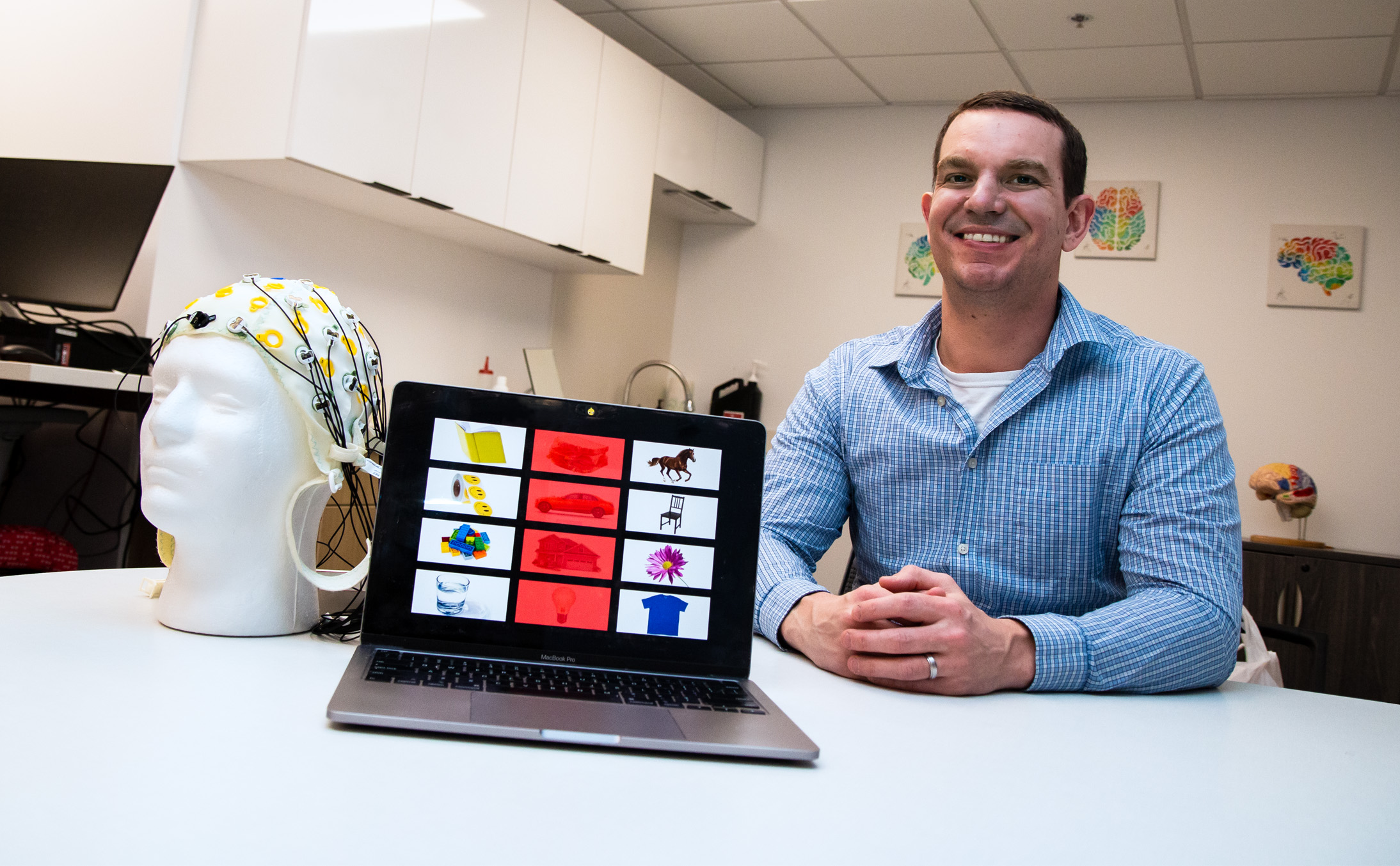 Kevin Pitt, assistant professor of special education and communication disorders, is leading a three-year project that uses brain-computer interface (BCI) technology to facilitate better communication for people with severe speech and physical impairments. (Kyleigh Skaggs, CYFS)