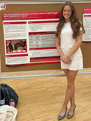 Jenna Rogers smiles next to her research poster (courtesy photo)