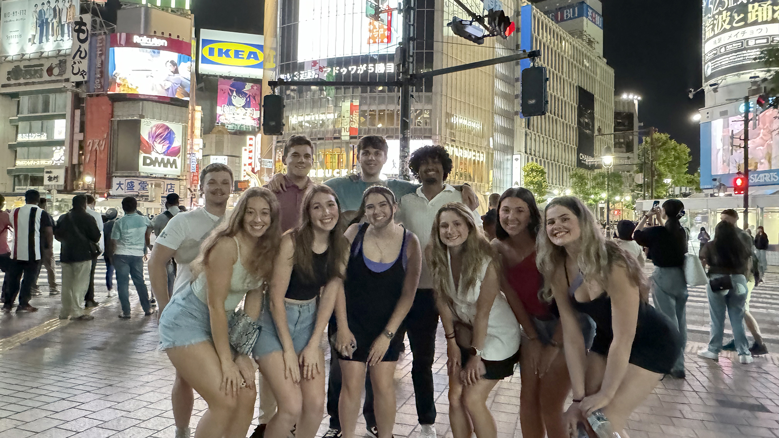 William Pipes and nine other Husker students pose for a group photo on a night in Japan