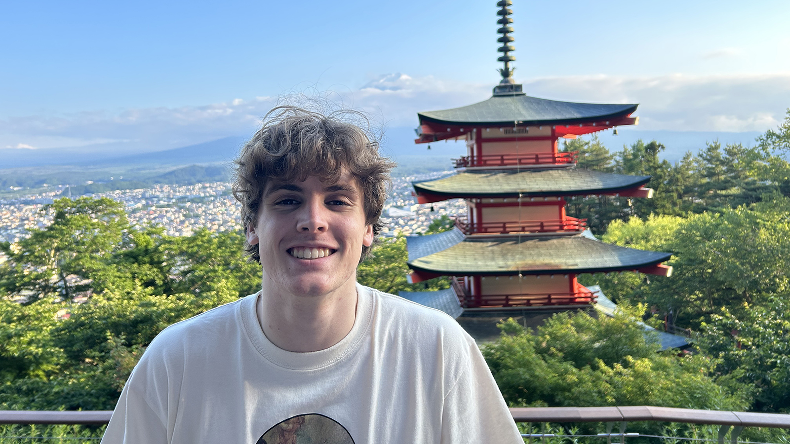 Nathan Heldt smiles with the Japanese Tower in the background