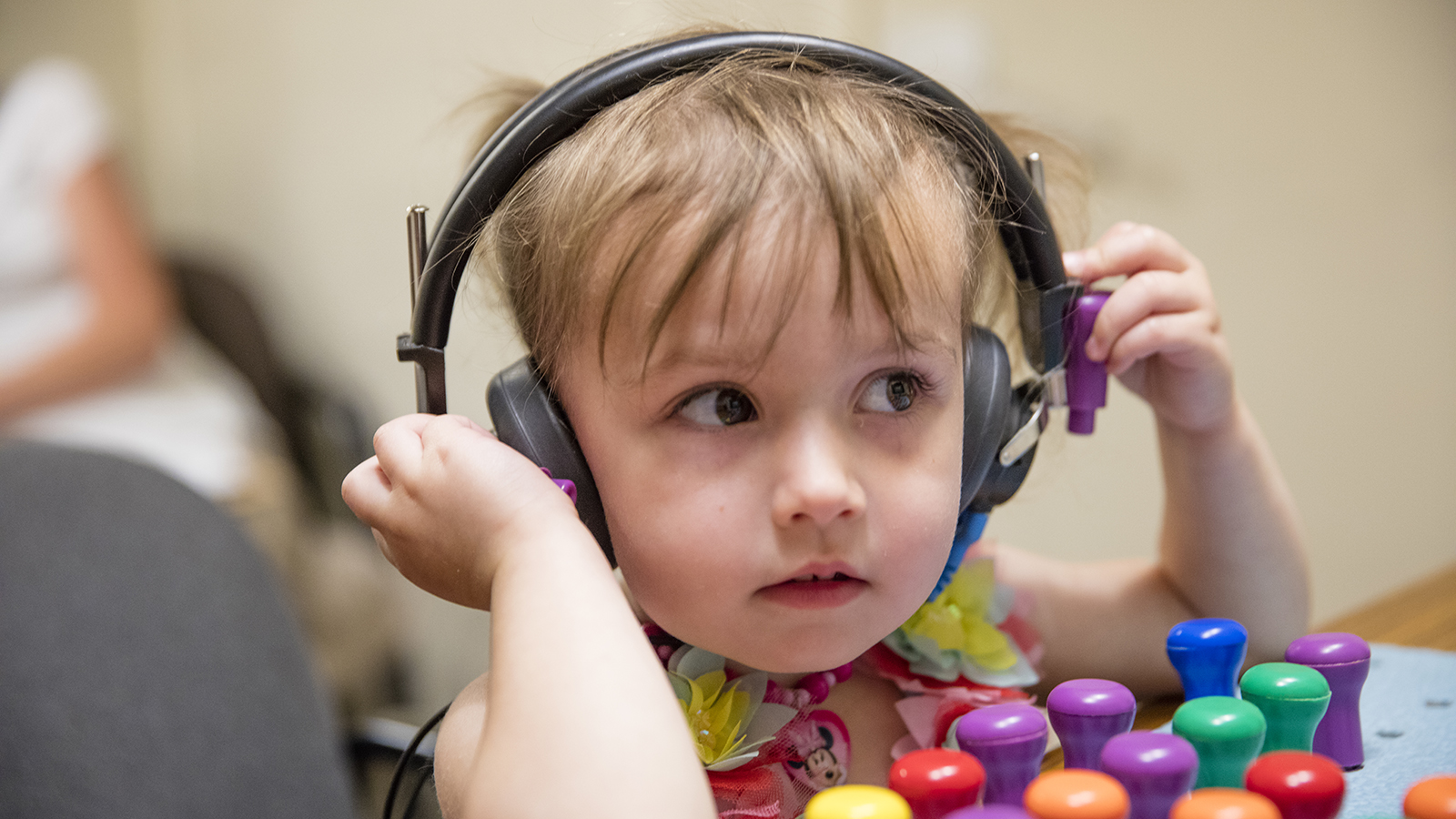 a young girl participates in a hearing test at the Barkley Speech Language and Hearing Clinic