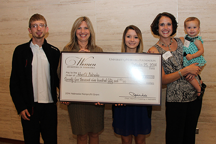 Stacie Ray, director of HearU Nebraska and associate professor of practice in audiology (second from left), accepts the grant award of $75,950 from Women Investing in Nebraska and is joined by her son, Brandon Ray (far left), and HearU Nebraska clients Hannah Lionberger (third from left), and Kelly Rausch (second from right) and her daughter Evie Rausch.
