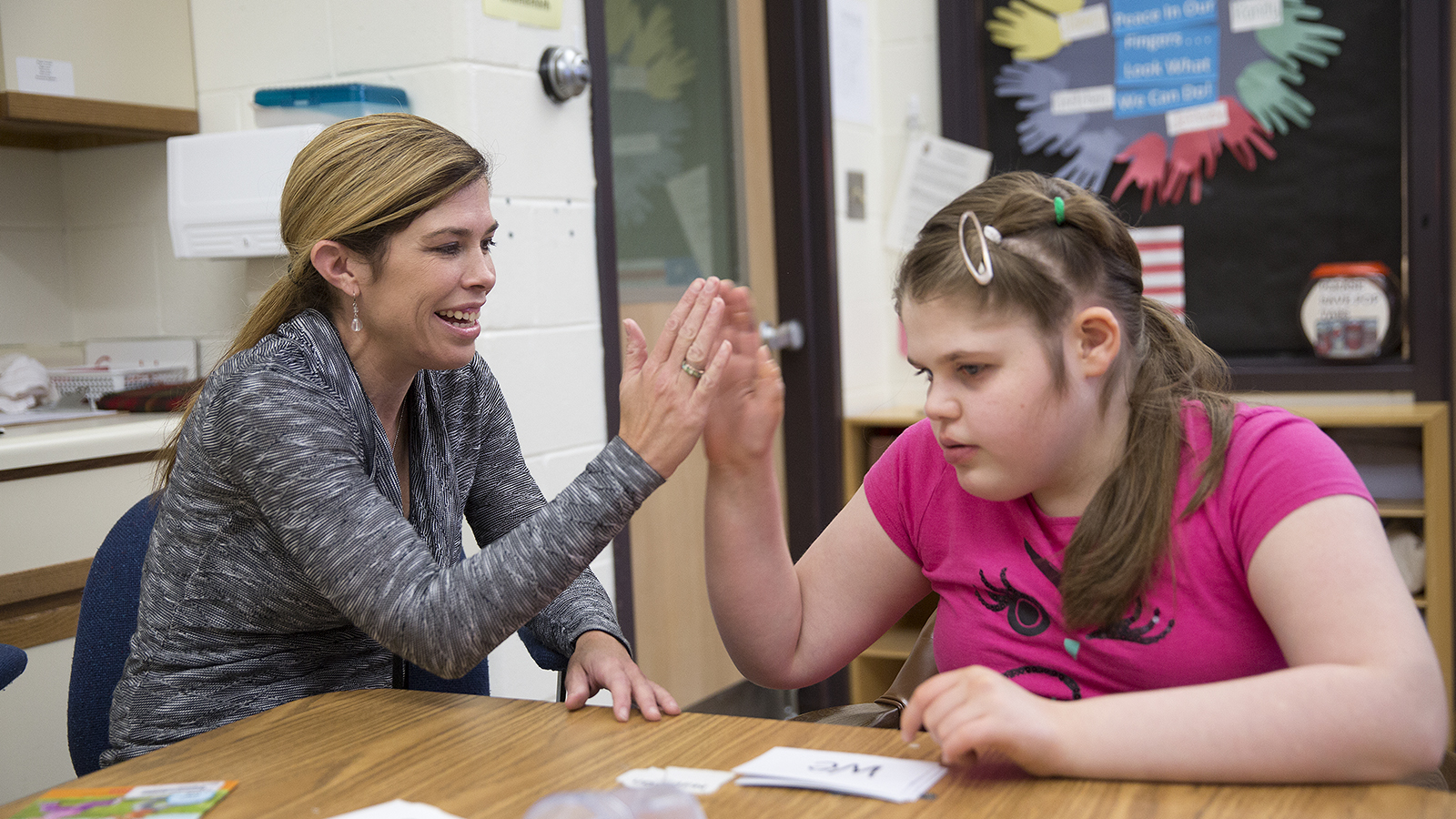 Rachel Zahn (right) gives a high-five to a student at NCECBVI.
