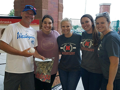 members of the Student Academy of Audiology pose for a photo at an event at a Lincoln Saltdogs baseball game