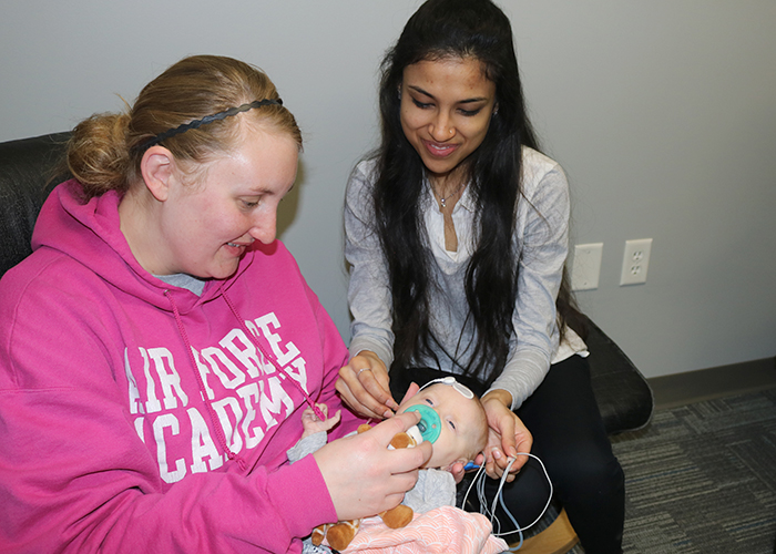a Husker AuD student conducts an infant hearing screening at the Barkley Speech Language and Hearing  Clinic
