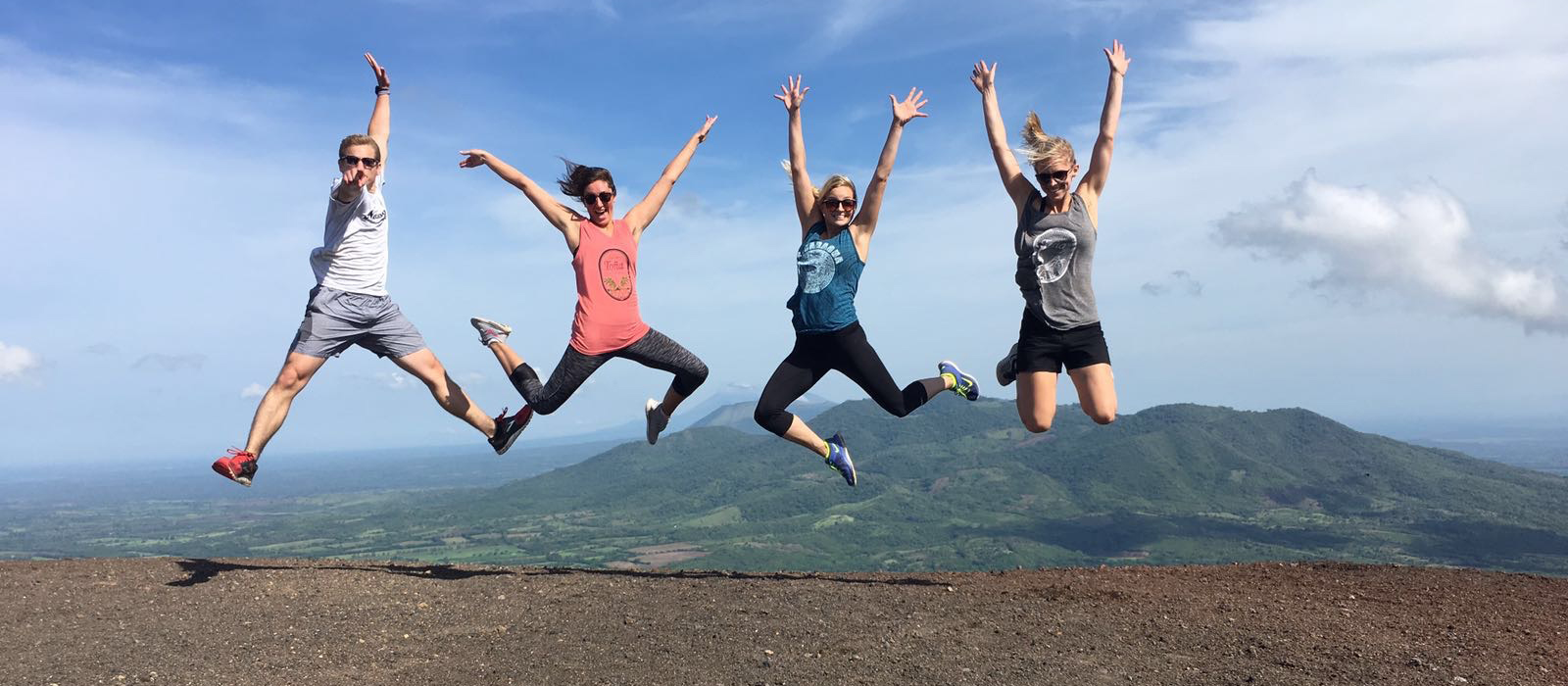 Husker students jump at the top of a scenic area in Nicaragua