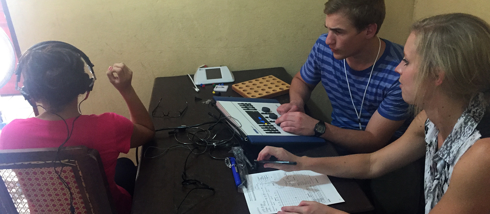 two Husker students conduct a hearing evaluation in Nicaragua