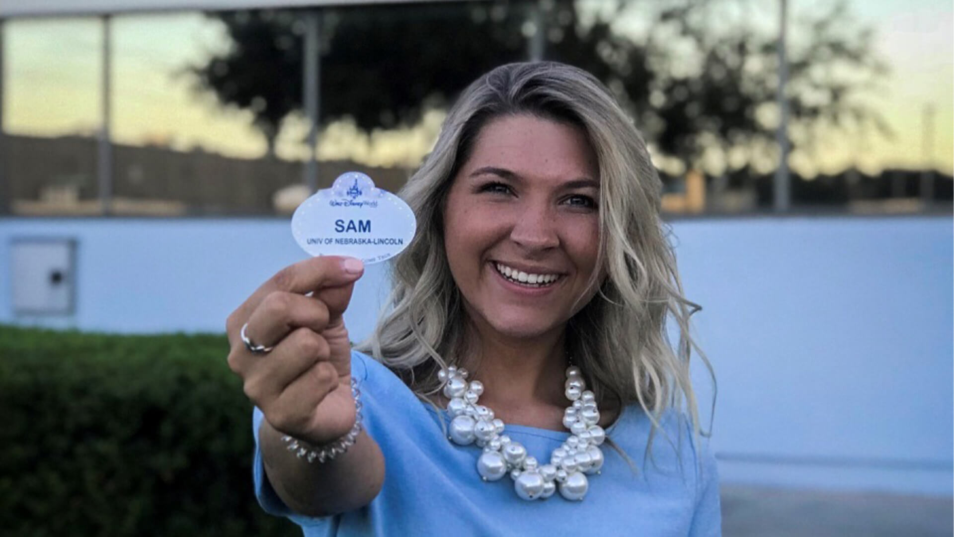 Student holding up name tag