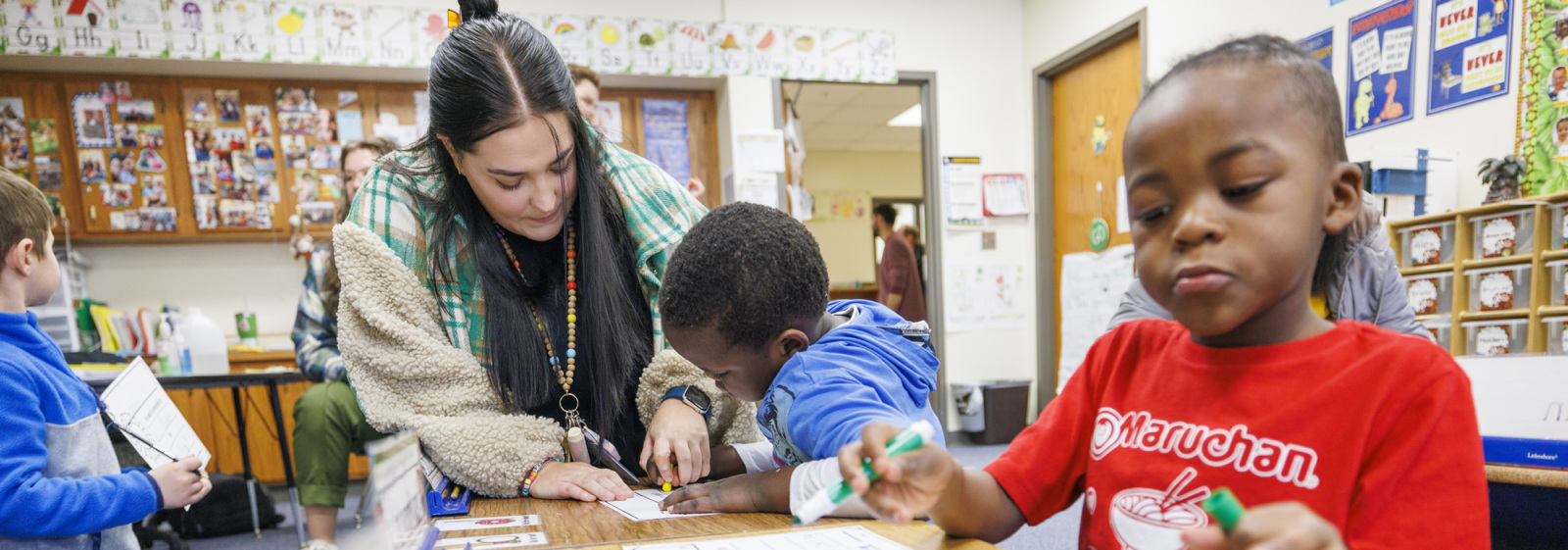 Instructors and students working in classroom