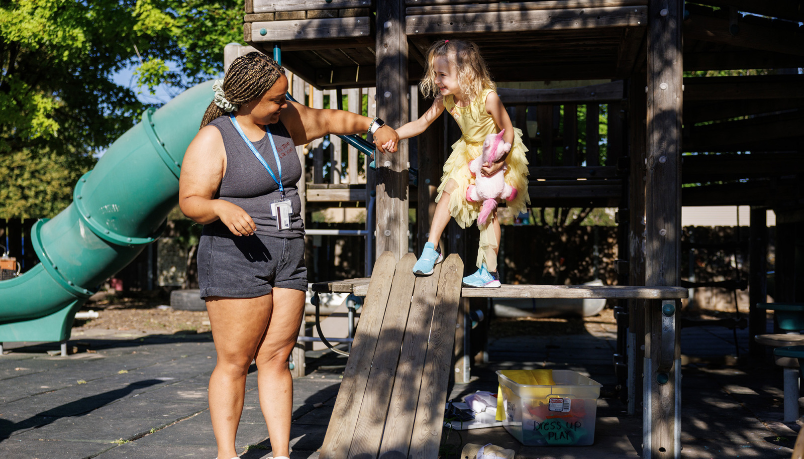 Woman playing with child on playground