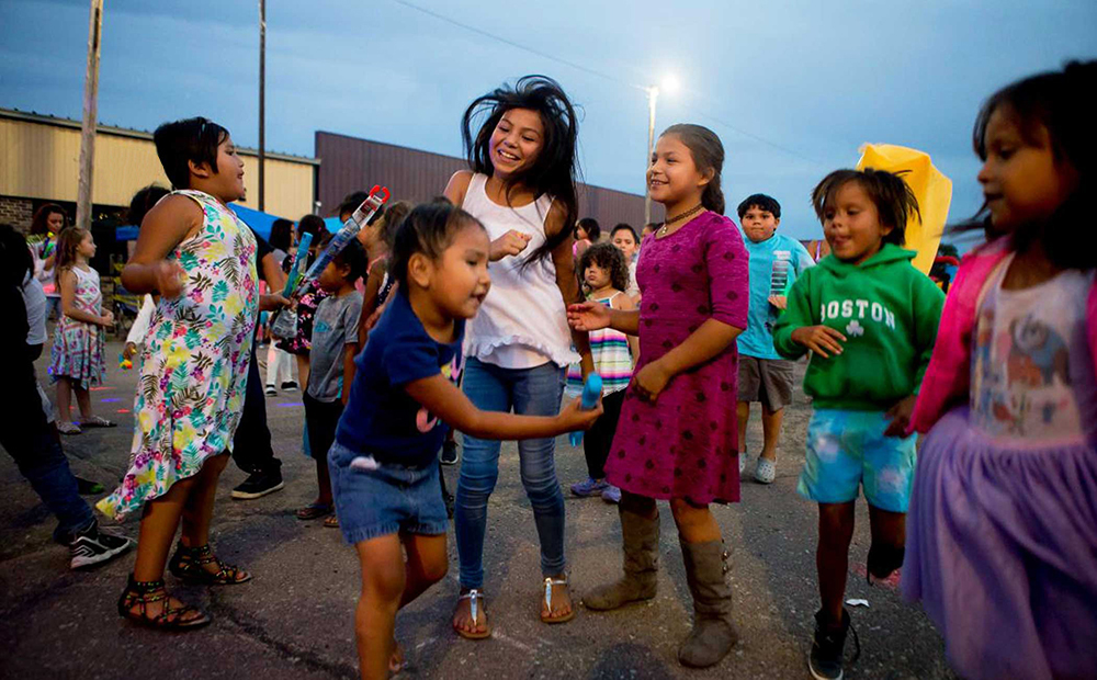 Kids dancing at street fair/event.