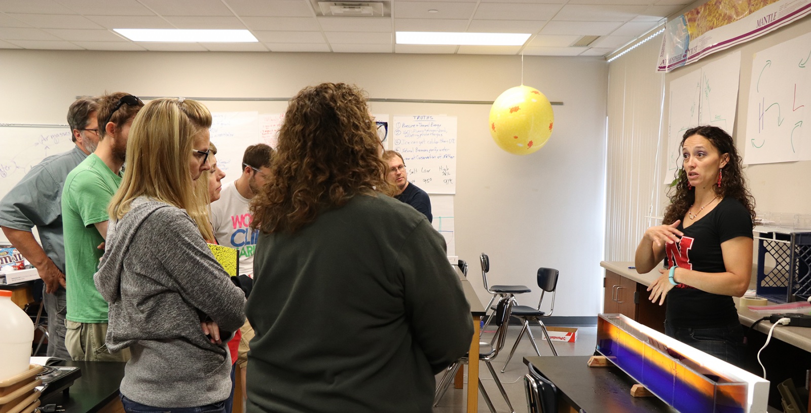 Group of students talking with instructor.