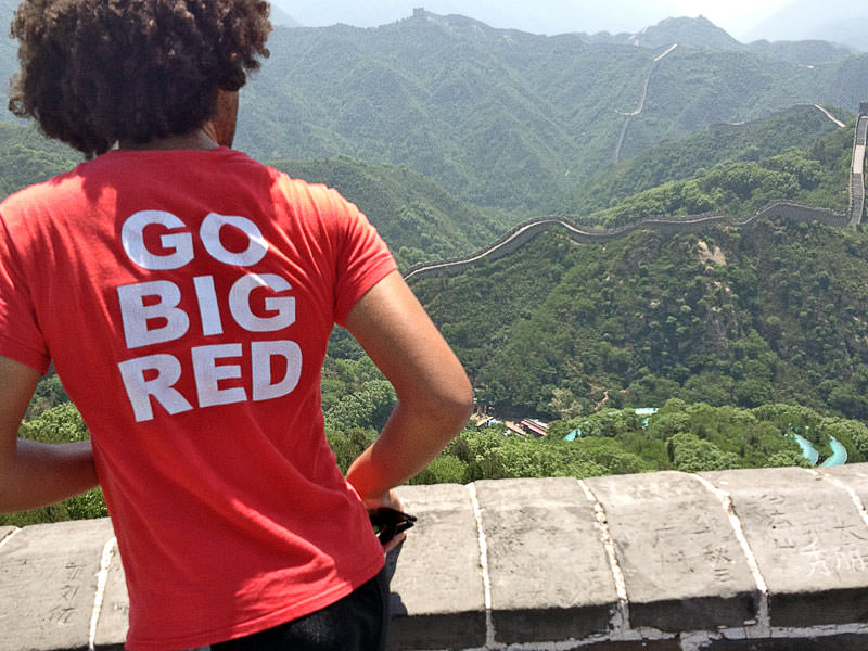 Student at great wall in China with GBR shirt on.