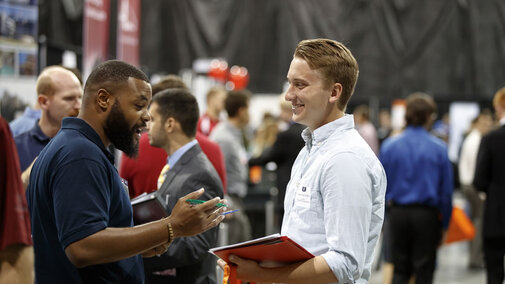 Two people conversing at an event