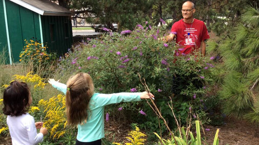 Eric with kids in Butterfly Garden