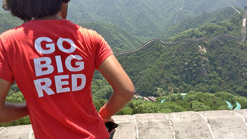 Student at great wall in China with GBR shirt on.