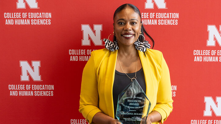 Shavonna Holman holds the Swanson Award