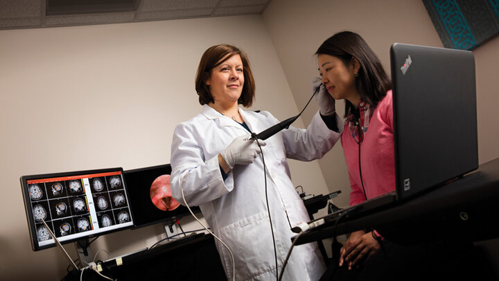 Angela Dietsch demonstrates equipment in her Sensorimotor Integration for Swallowing and Communication Lab