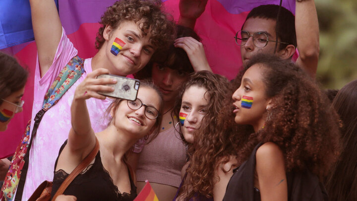 Group taking a photo on a phone. 