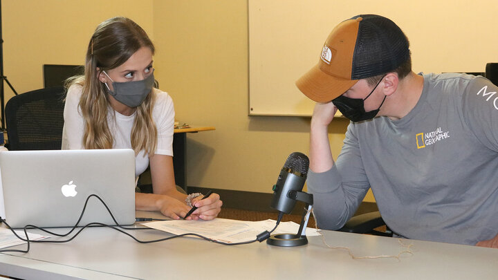 A Husker speech-language pathology graduate student explains voice screening results to a student from the Johnny Carson School of Theatre and Film.