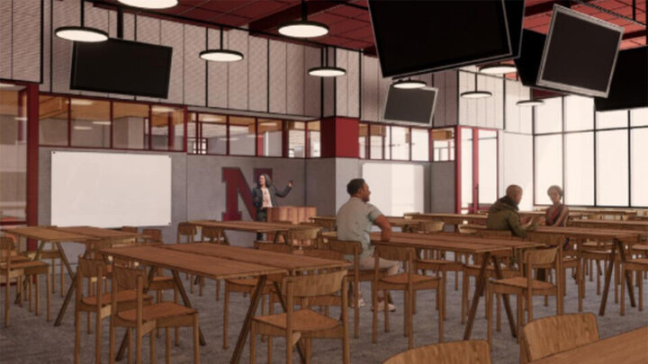 Architectural rendering showing a classroom with wooden tables and chairs and several television screens.