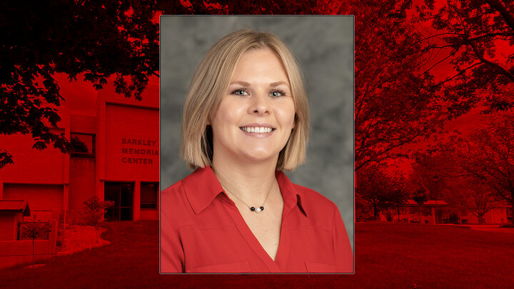 Professional headshot of Ciara Ousley on red background. 