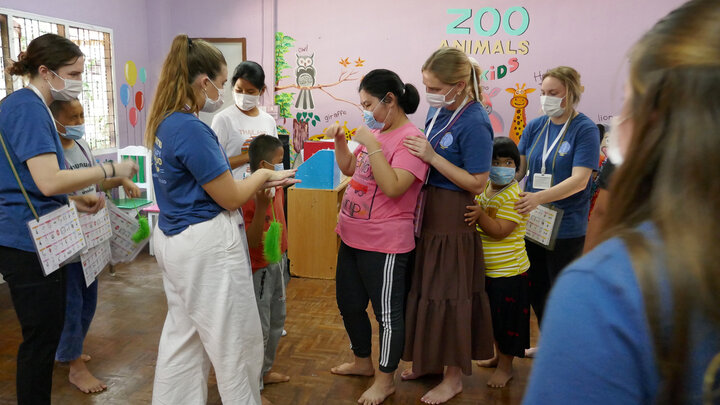 Elsa Wilcox and other Husker students assist children in Thailand with communicating using Augmentative and Alternative Communication (AAC)