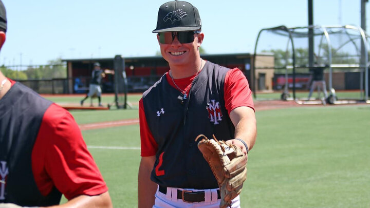 Rhett Stokes smiles as he walks off the baseball field