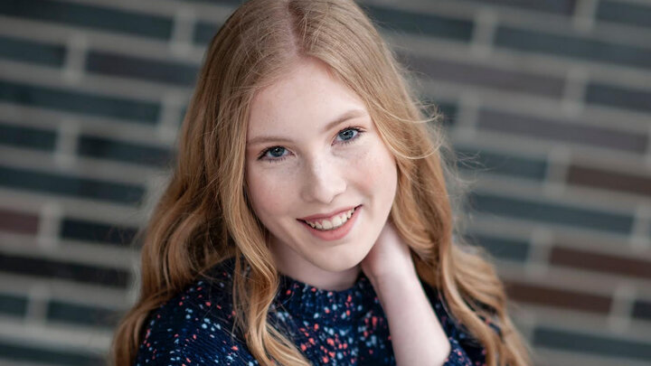 Maddy Stolcpart professional portrait with brick background