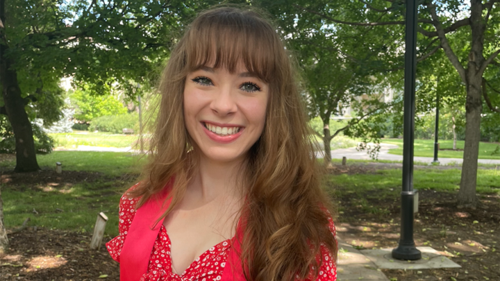 Kylee Preuss portrait photo on a sidewalk surrounded by trees