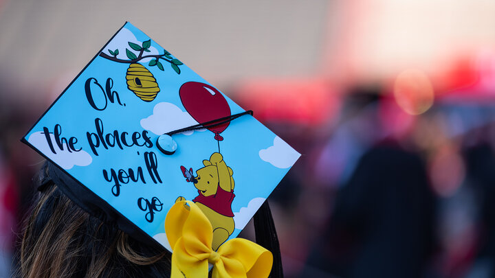 graduation cap decorated with Winnie the Pooh and the words 