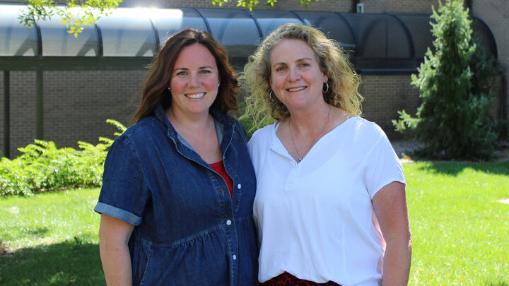 Emily Fisher and Pam Bazis pose for a photo together outside the Barkley Memorial Center on UNL's East Campus