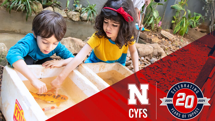 two children explore water play, CYFS logo and CYFS 20th anniversary logo in bottom right