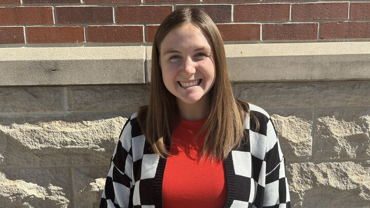 Kylee Ellinger headshot in front of brick building