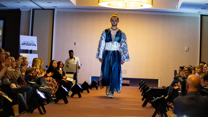 model walks the runway with a design created by a TMFD student at Project Funway 2023