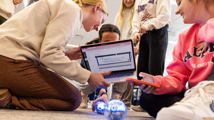 Students in TEAC 259A work in a group to program robots (photo by Loren Rye)