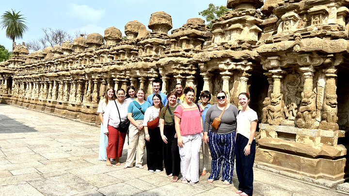 Husker students pose for a group photo at an ancient temple in India