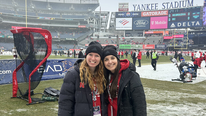 Elena Jetensky and another Husker student smile for a photo at Yankee Stadium