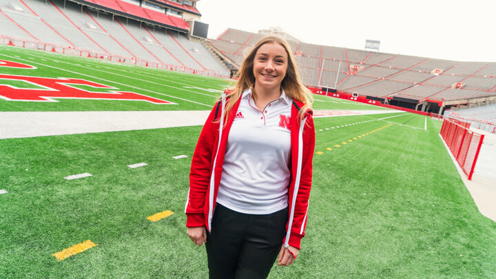 Kristen Nett stands for a photo on the field at Memorial Stadium