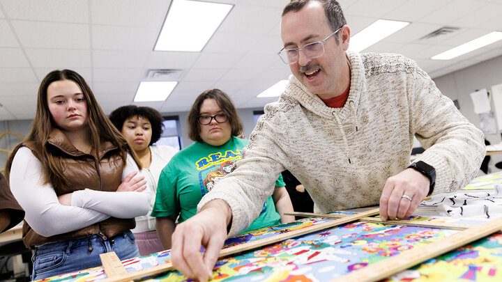 Michael Burton, assistant professor in the Department of Textiles, Merchandising & Fashion Design, identifies a pattern in a textile during his Advanced Design for Printed Textiles class inside the Gwendolyn A. Newkirk Human Sciences Building