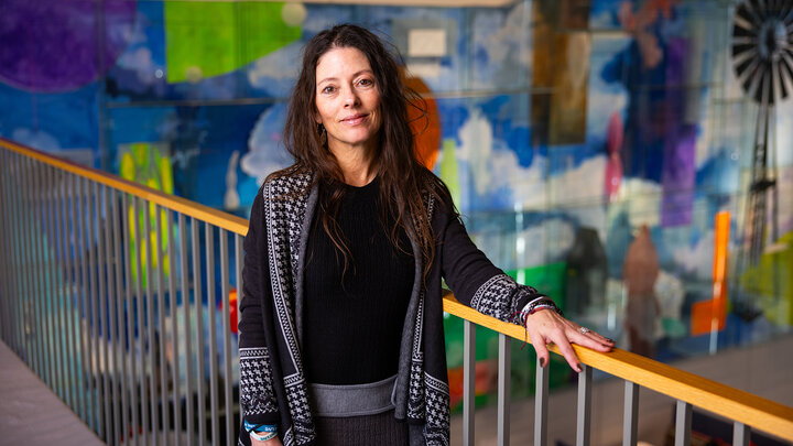 Rochelle Dalla portrait photo on walkway overlooking living room space in Carolyn Pope Edwards Hall